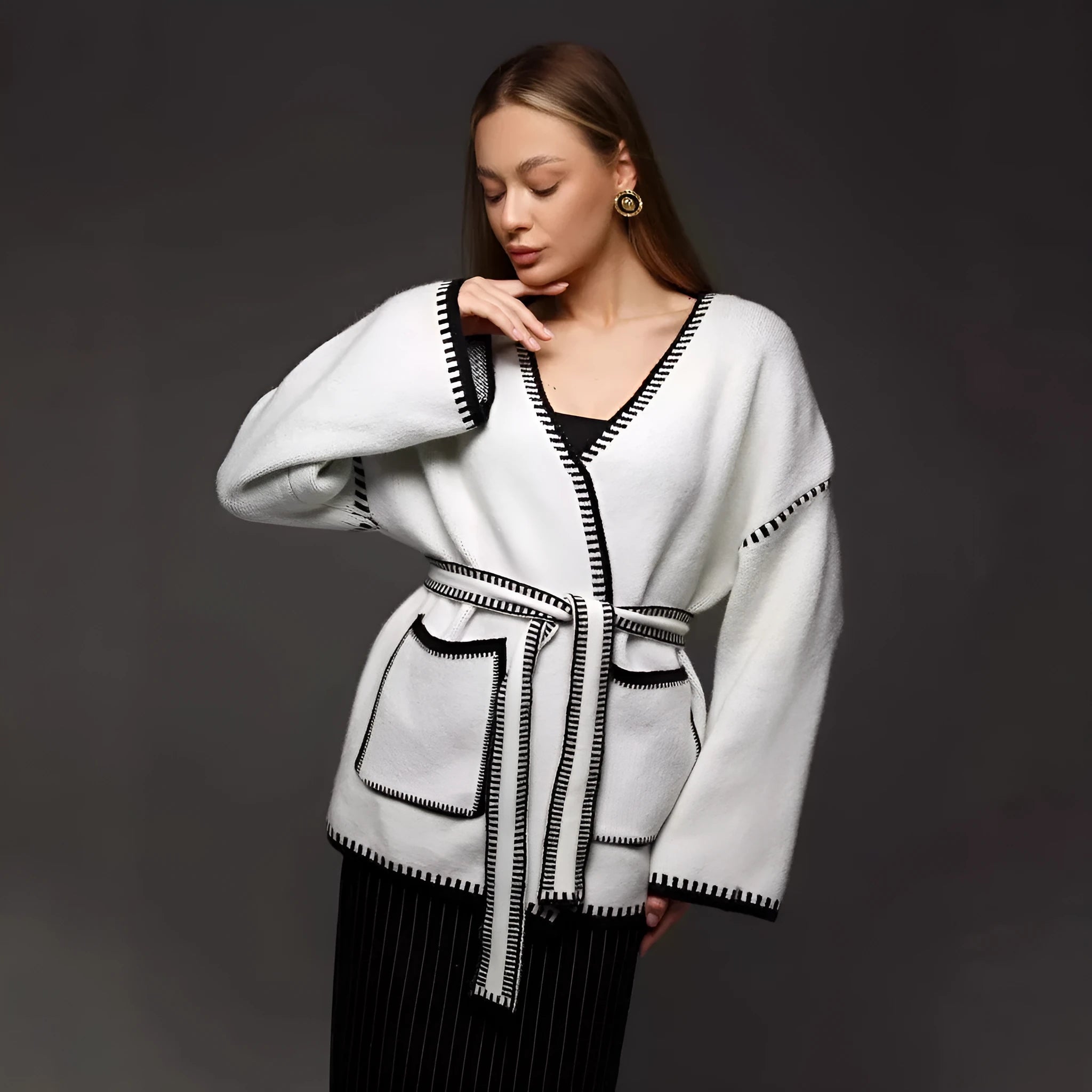 Lace-up front knitted cardigan in a loose fit, shown in black, camel, and white colour options.
