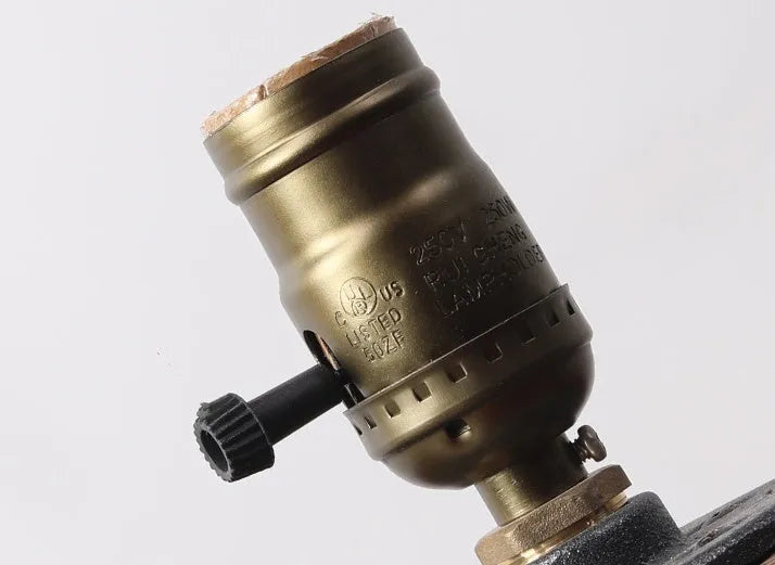 Small wood and iron water pipe style table lamp on a table