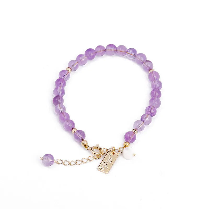 Natural crystal bracelet with romantic lavender amethyst beads, available in dark or light colour, on a plain background