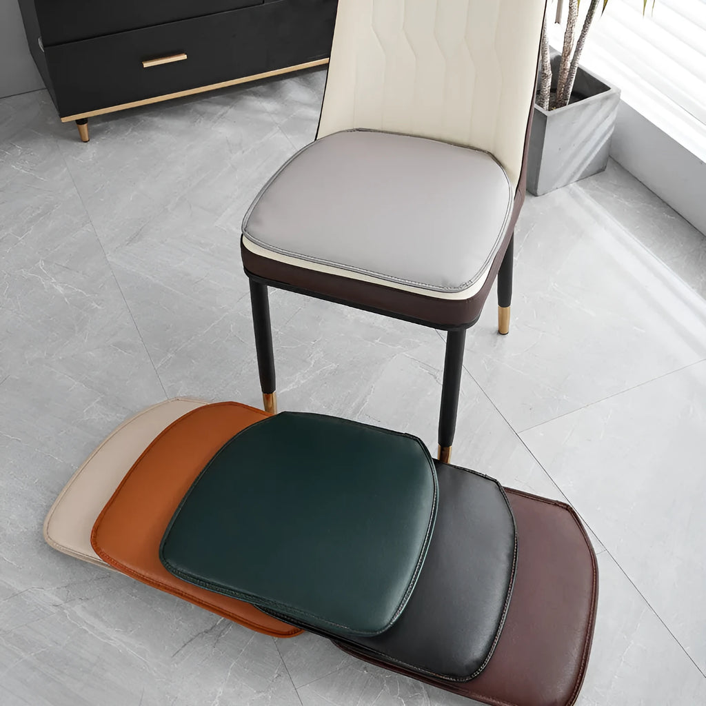 Leather horseshoe-shaped seat cushion on a chair, showing non-slip base and solid colour.