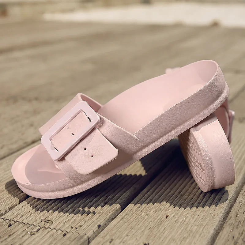 Women's grey blue buckle slipper made of soft EVA material on a plain background
