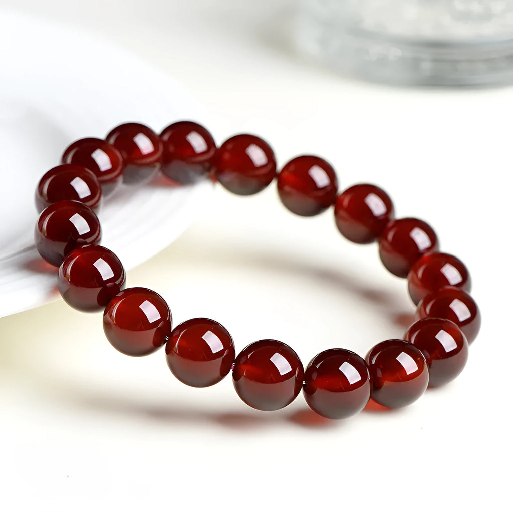 Natural orange red garnet ball bracelet with ruyi element in retro unisex design on wrist