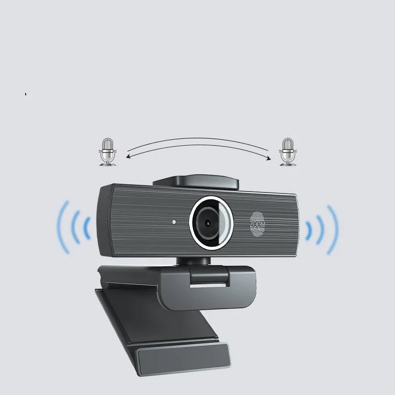 Black USB computer webcam with magnetic privacy cover on a desktop