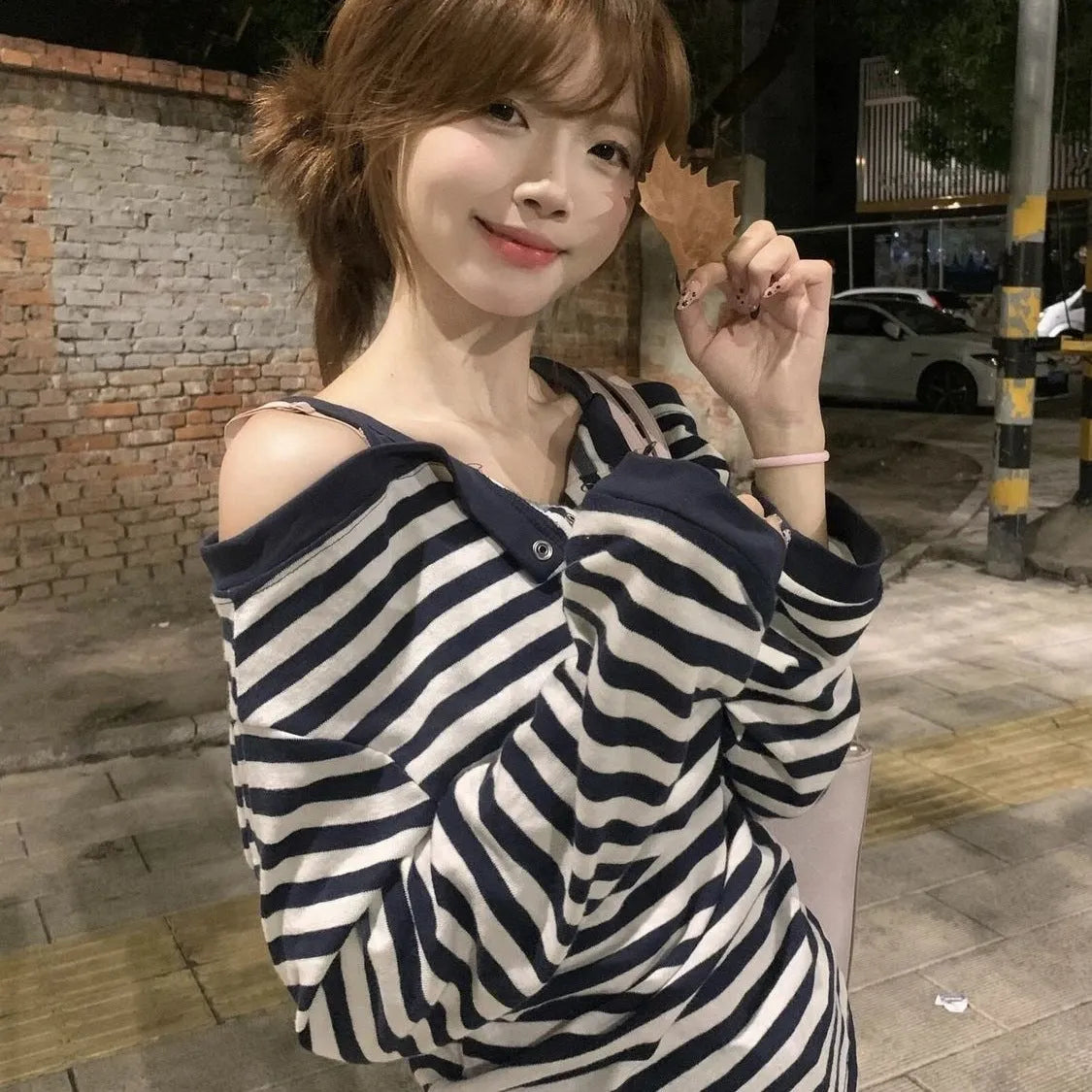 Dark blue Korean-style oversized women's T-shirt with embroidered stripes and button details on long sleeves