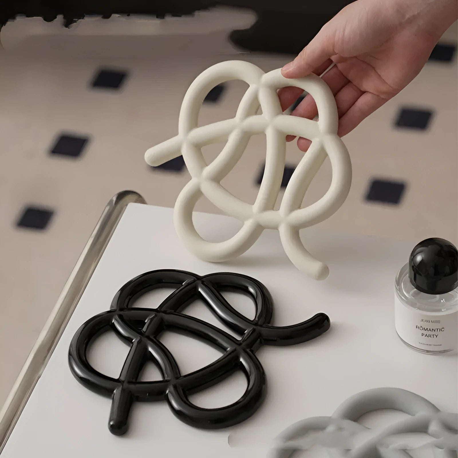 Ceramic heat proof mat with irregular shape in bright black colour on dining table