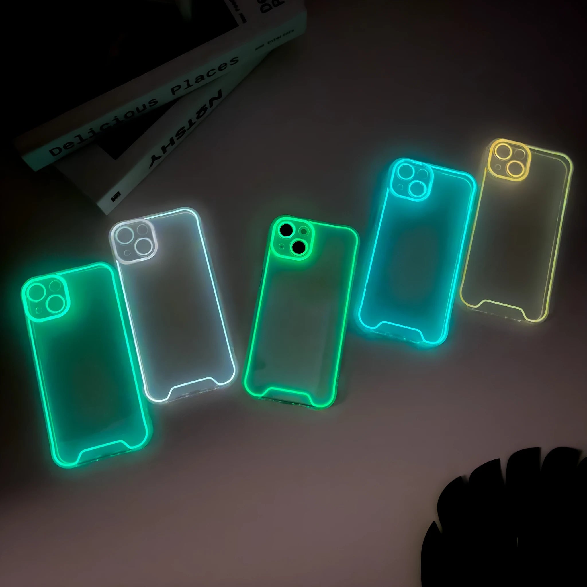 Glow in the dark soft TPU iPhone case shown in green, orange, blue, yellow, and pink colours