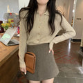 Long-sleeved beige viscose knit cardigan top shown on a hanger, demonstrating its loose fit and regular sleeve length.