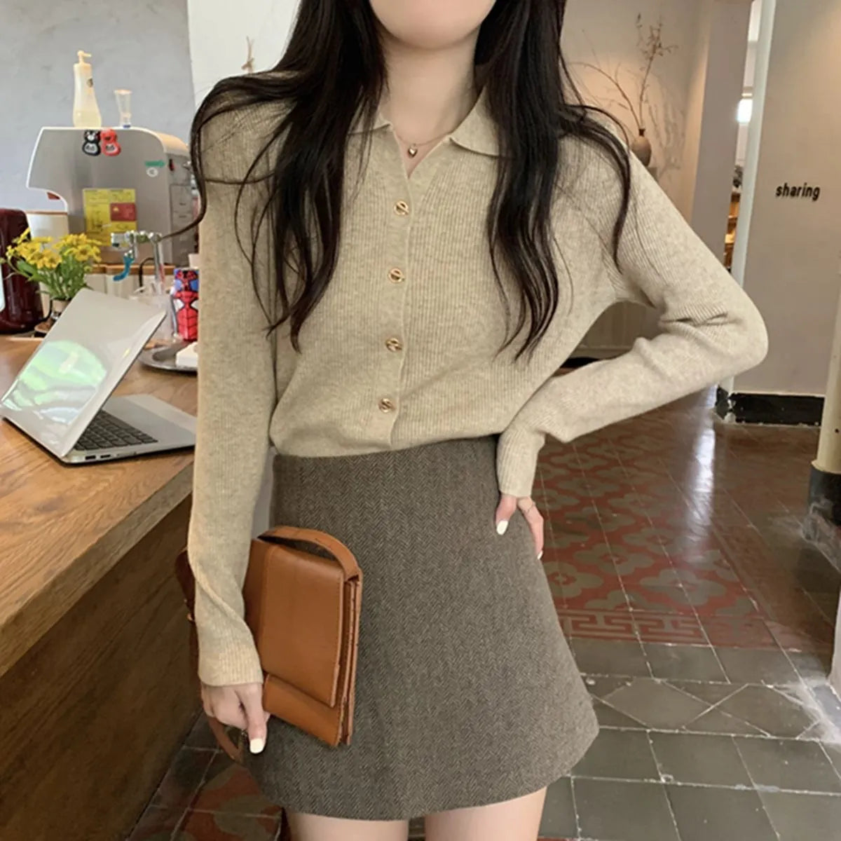 Long-sleeved beige viscose knit cardigan top shown on a hanger, demonstrating its loose fit and regular sleeve length.