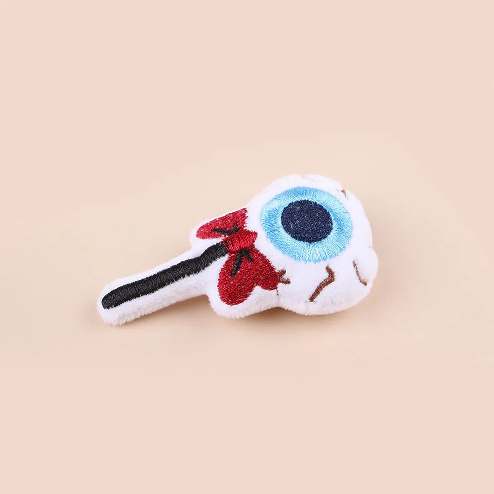 Plush cat teaser wand toy with colourful candy and skull designs on small attachment