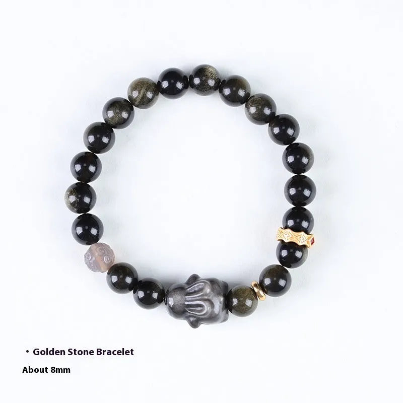 Handmade unisex lying rabbit Jin Yaoshi obsidian bracelet with gray agate and brass beads on neutral background