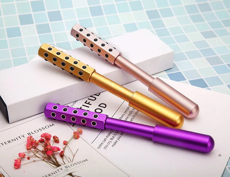 Purple handheld roller massage instrument with 24 germanium ceramic beads for facial and eye care.