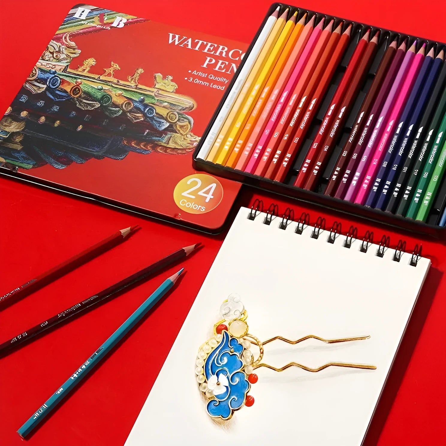 Wooden tin box open to show 24 water-soluble coloured pencils.