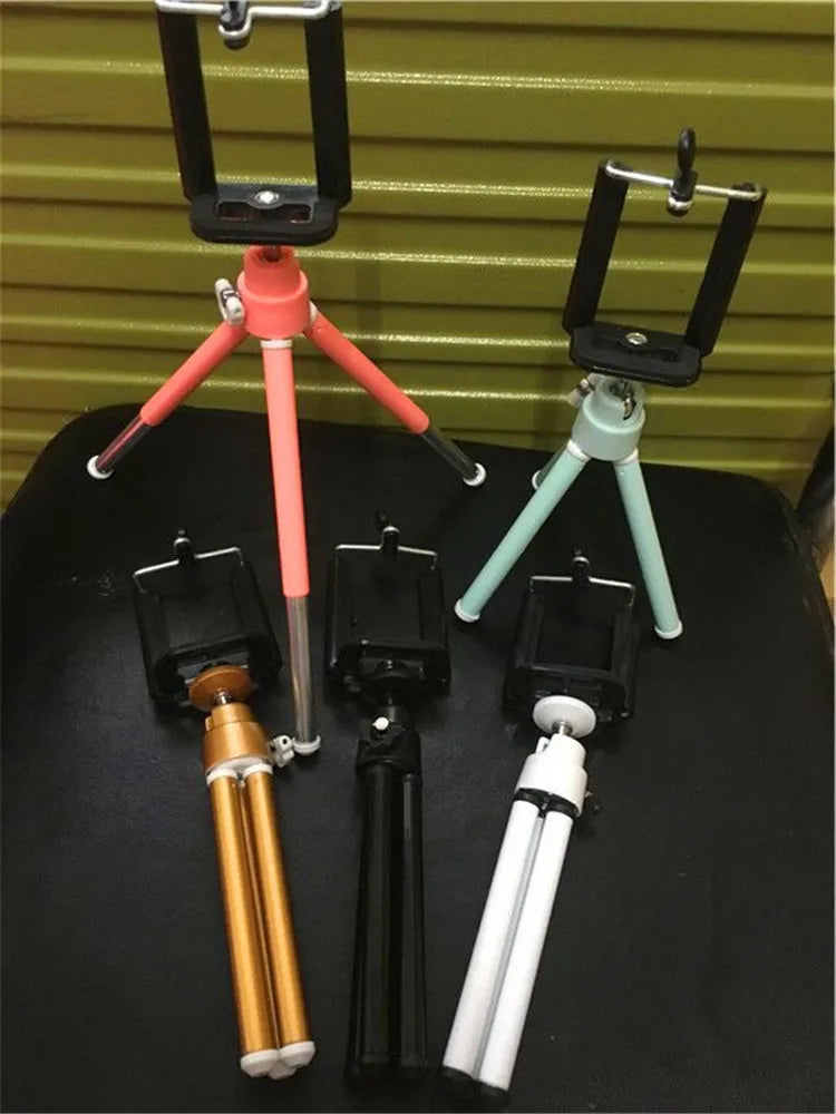 Black desktop phone holder with two-section adjustable metal bracket and clamp base