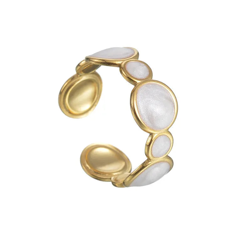 A stainless steel geometric ring with an adjustable opening on a plain background.