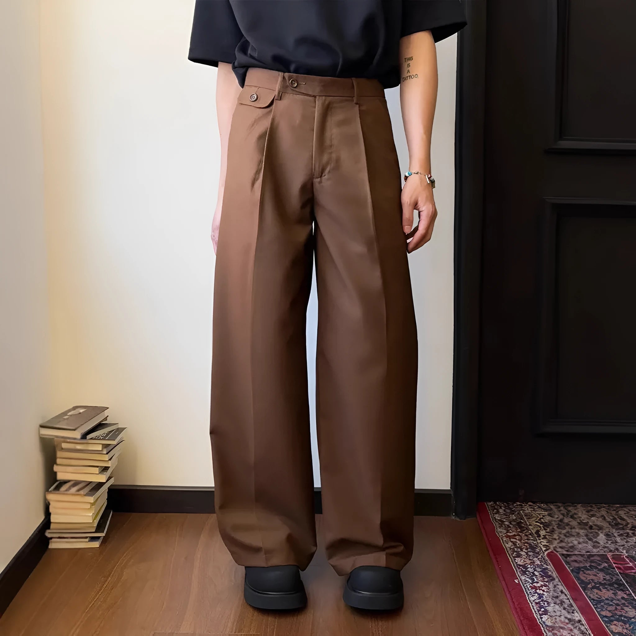 Men's brown straight-leg casual suit trousers with a loose, wide-leg fit on a hanger.
