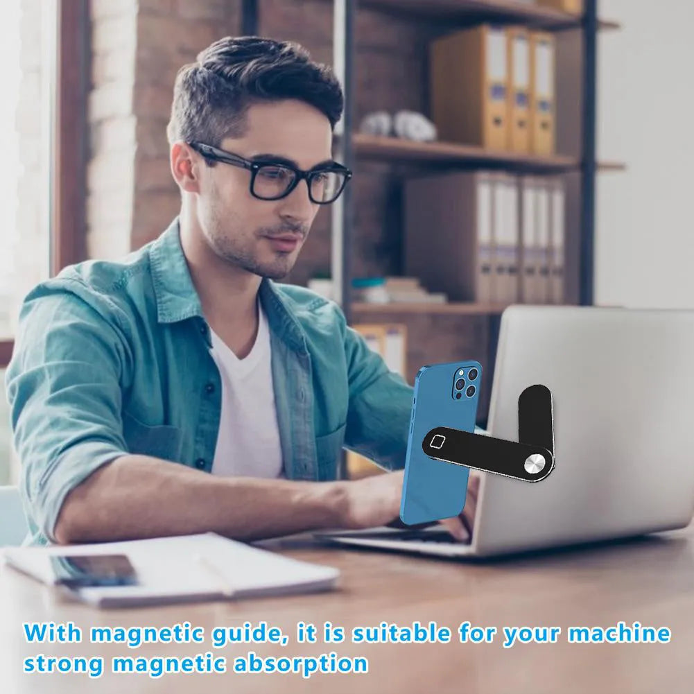 Black aluminium laptop phone holder with magnetic mount attached to laptop side