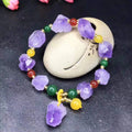 Natural shaped purple amethyst gemstone bracelet with a carved Fu character charm.