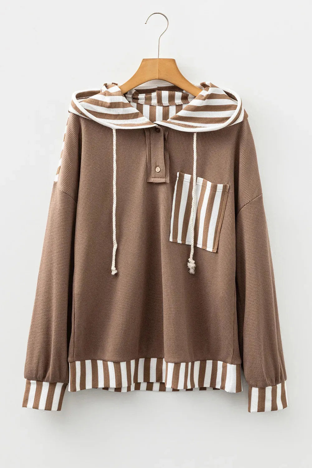 Straw yellow long sleeve hoodie with waffle texture, striped patchwork, button neck, and drawstring hood.
