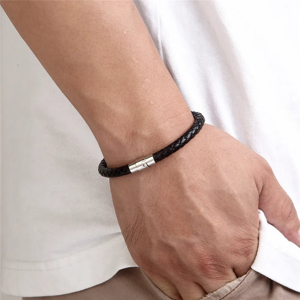 Geometric titanium steel bracelet with magnetic clasp shown in a unisex style on a wrist.