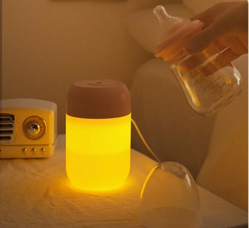 White cylindrical USB-powered mini humidifier on a desktop.