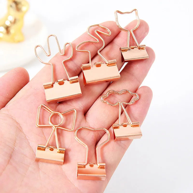 Golden decorative alligator clip with choice of flamingo, love, clouds, cat, cactus, or bow motif designs