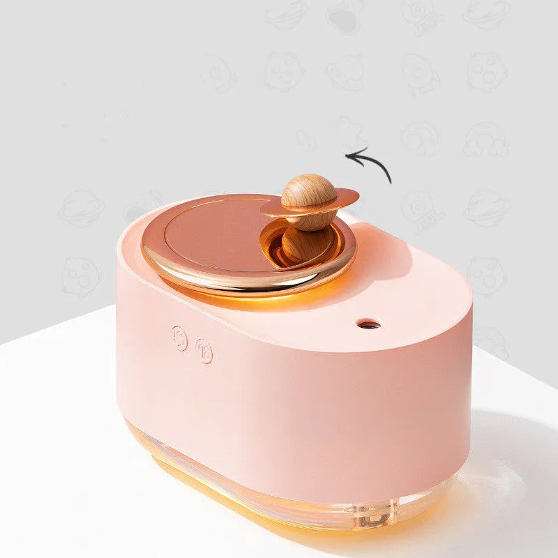 Green rotating planet-shaped USB humidifier with night light on wooden surface