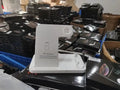 Folding 4-in-1 wireless charger showing multiple charging pads in open position with smartphone placement