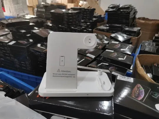 Folding 4-in-1 wireless charger showing multiple charging pads in open position with smartphone placement