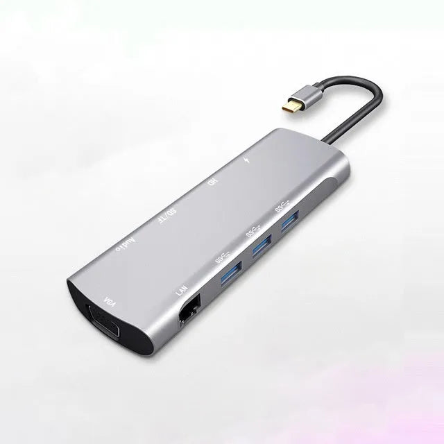Grey aluminium alloy USB-C docking station with HDMI, VGA, and USB 3.0 ports and integrated 140mm cable