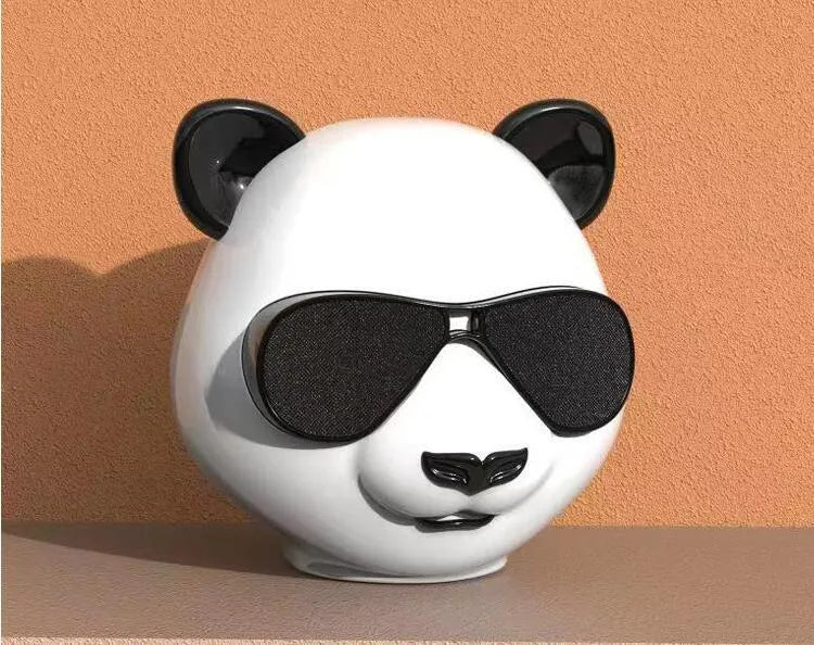 Portable mini Bluetooth speaker in classic style showing front grille and compact size.
