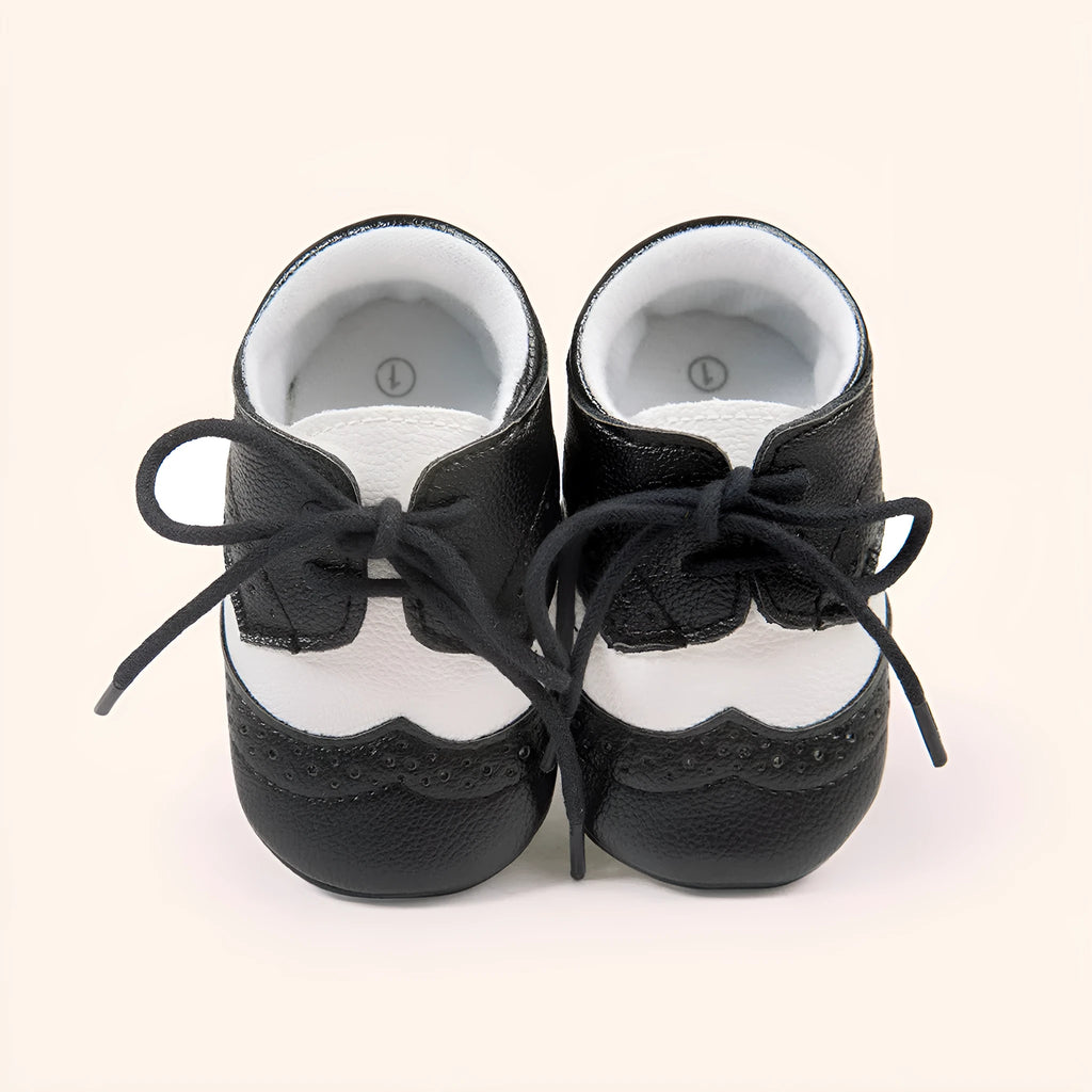 Vintage style baby shoes with soft soles in black synthetic leather