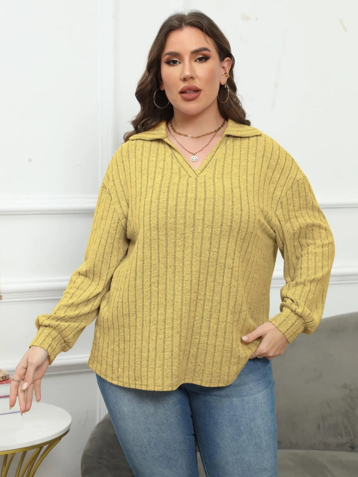 Plus size women's gray fleece pullover with a polo collar and lantern sleeves on a hanger.