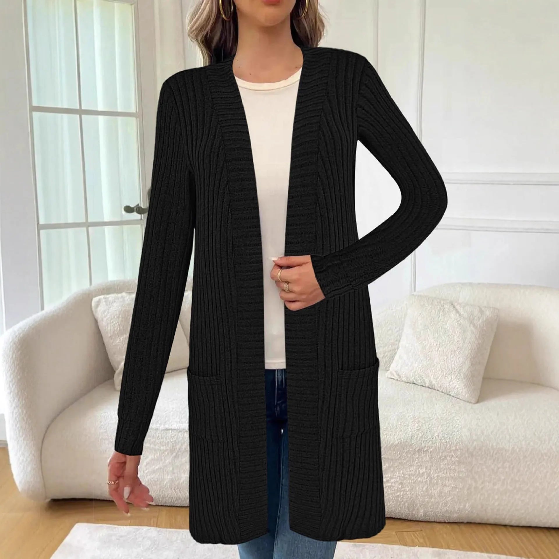 Long sleeve loose grey knitted cardigan jacket with pockets on a hanger