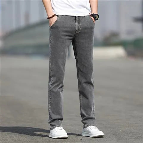 Men's smoky grey low waist straight leg jeans with a zipper fly, shown on a hanger.