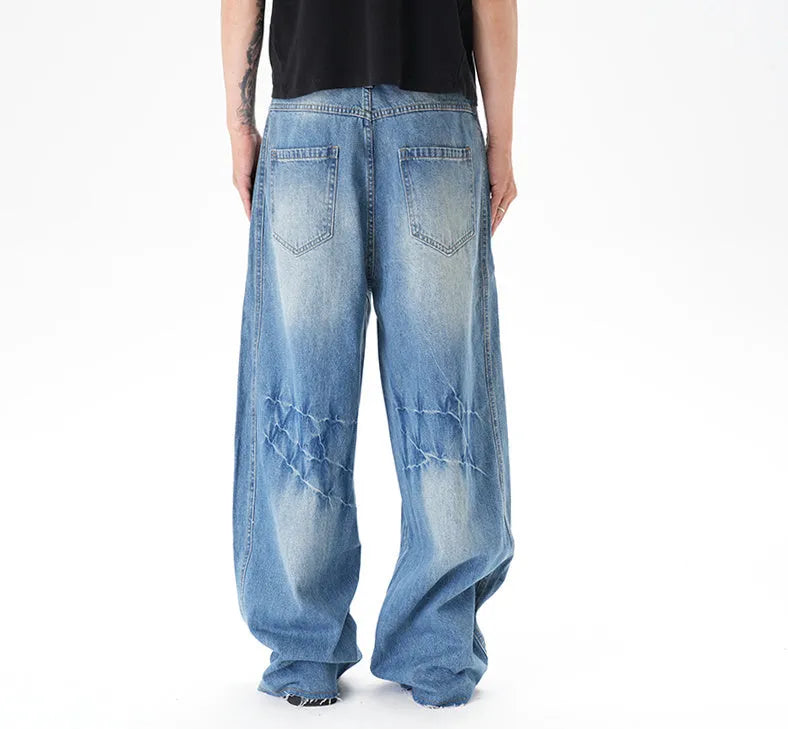 Light blue vintage washed wide leg machete jeans with zip fly on a model