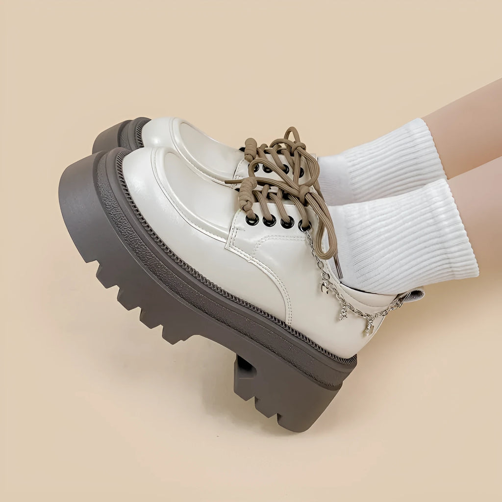 British-style white platform leather shoes with chunky heel and front lace-up closure