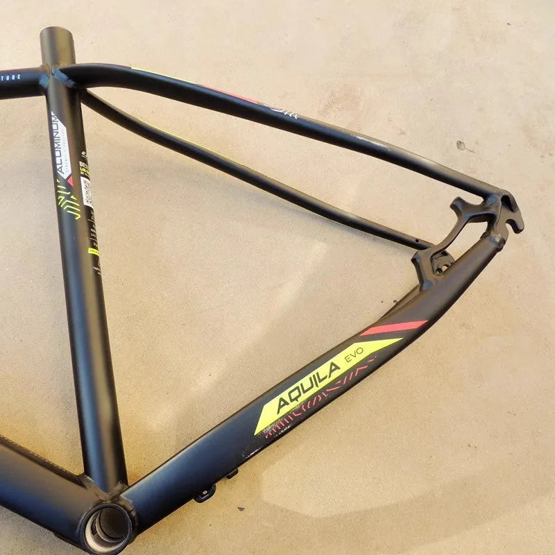 Black green 29-inch aluminium mountain bike frame with internal cable routing ports and disc brake mount.