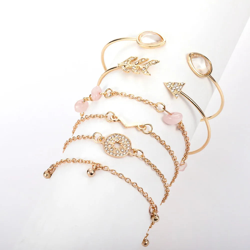 Six gold zinc alloy bracelets with V-shaped, water droplet, arrow and spot drill designs