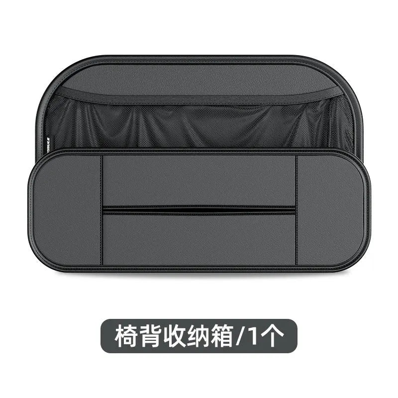Black leather car seat rear storage bag showing its box shape and size against a vehicle seat.