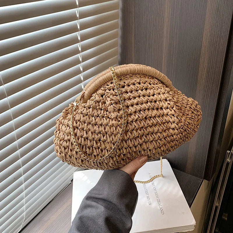 Khaki shell-shaped straw shoulder bag for women with chain detail and zippered pocket.