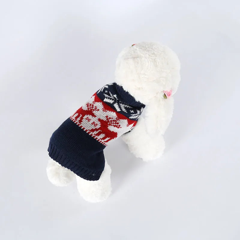 Navy blue knitted Christmas sweater for a dog on a hanger.