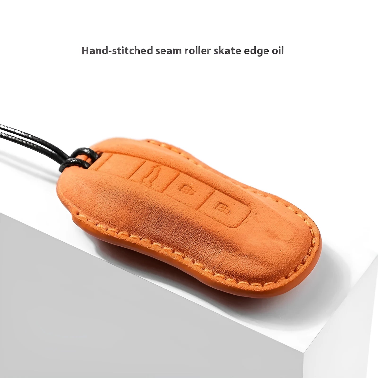 Suede car key cover in cement gray with style A design on a tabletop