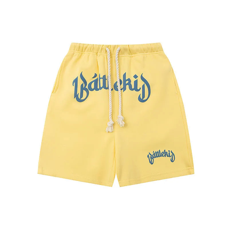Loose-fit cotton blend cropped shorts in black, shown in a casual streetwear style.
