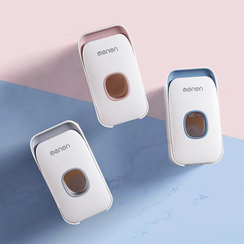 Automatic toothpaste dispenser unit in blue, grey, and pink colours made from ABS plastic.
