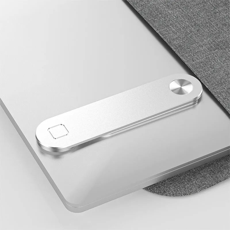 Black aluminium laptop phone holder with magnetic mount attached to laptop side