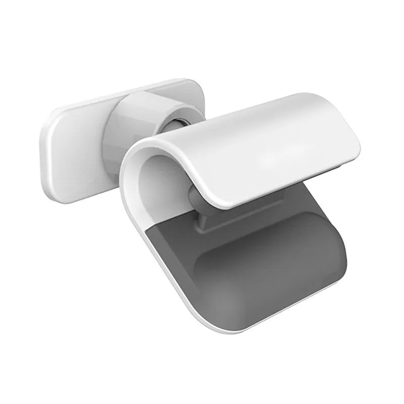 Black gravity car phone holder with 360-degree rotating bracket mounted on a car dashboard holding a mobile phone.