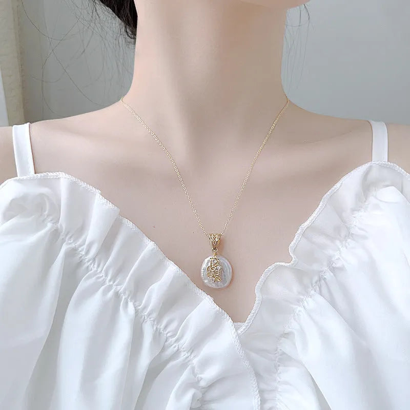 Women's matching baroque pearl geometry necklace with O-ring chain and earring set on display