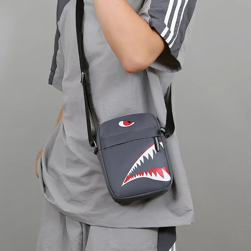 Men's black Oxford cloth crossbody bag with animal print pattern and adjustable shoulder strap