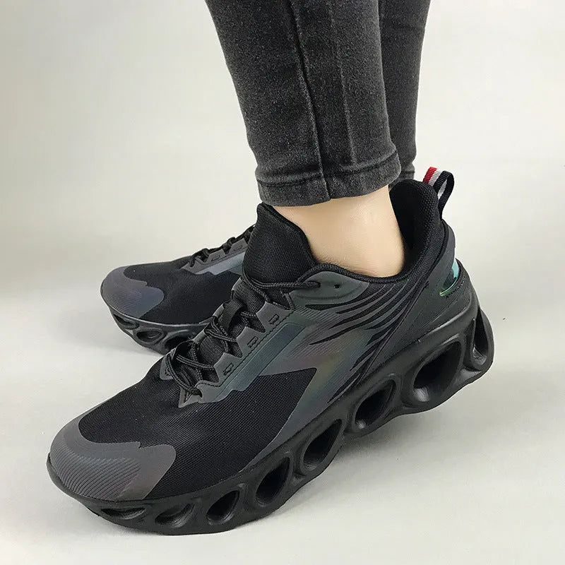 Men's low-top black mesh sports sneakers with white sole and lace-up closure on a white background
