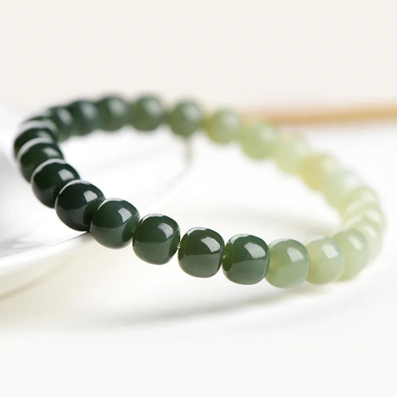 Natural Hetian jade bracelet with clear water gradient on wrist.
